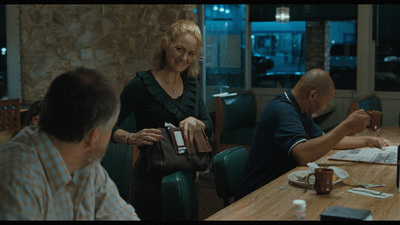 a group of people sitting at a table in a restaurant