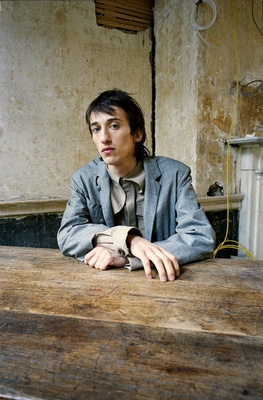 a man sitting at a wooden table in a room