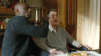 a man sitting at a table with a plate of food in front of him