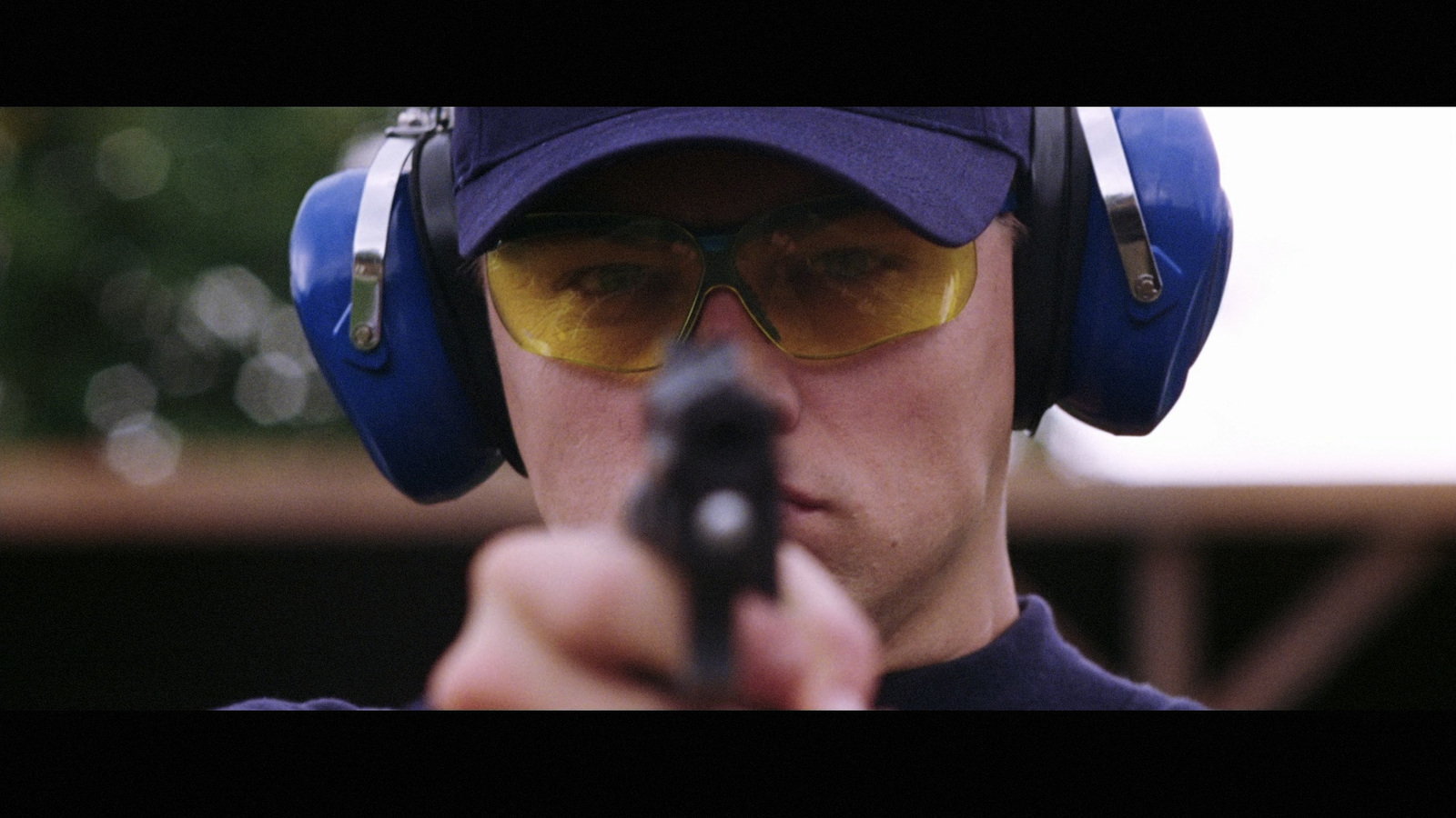 a man wearing headphones and holding a gun