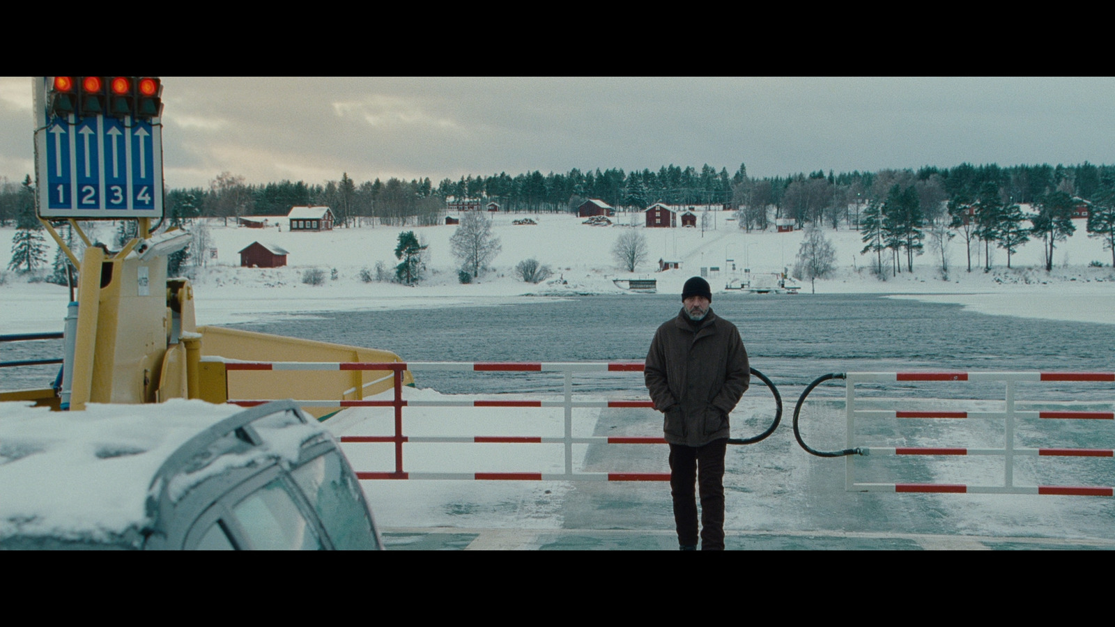 a man is standing in the snow with a tennis racket