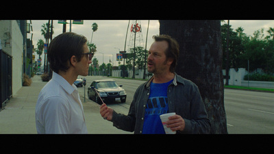 a couple of men standing next to each other on a street