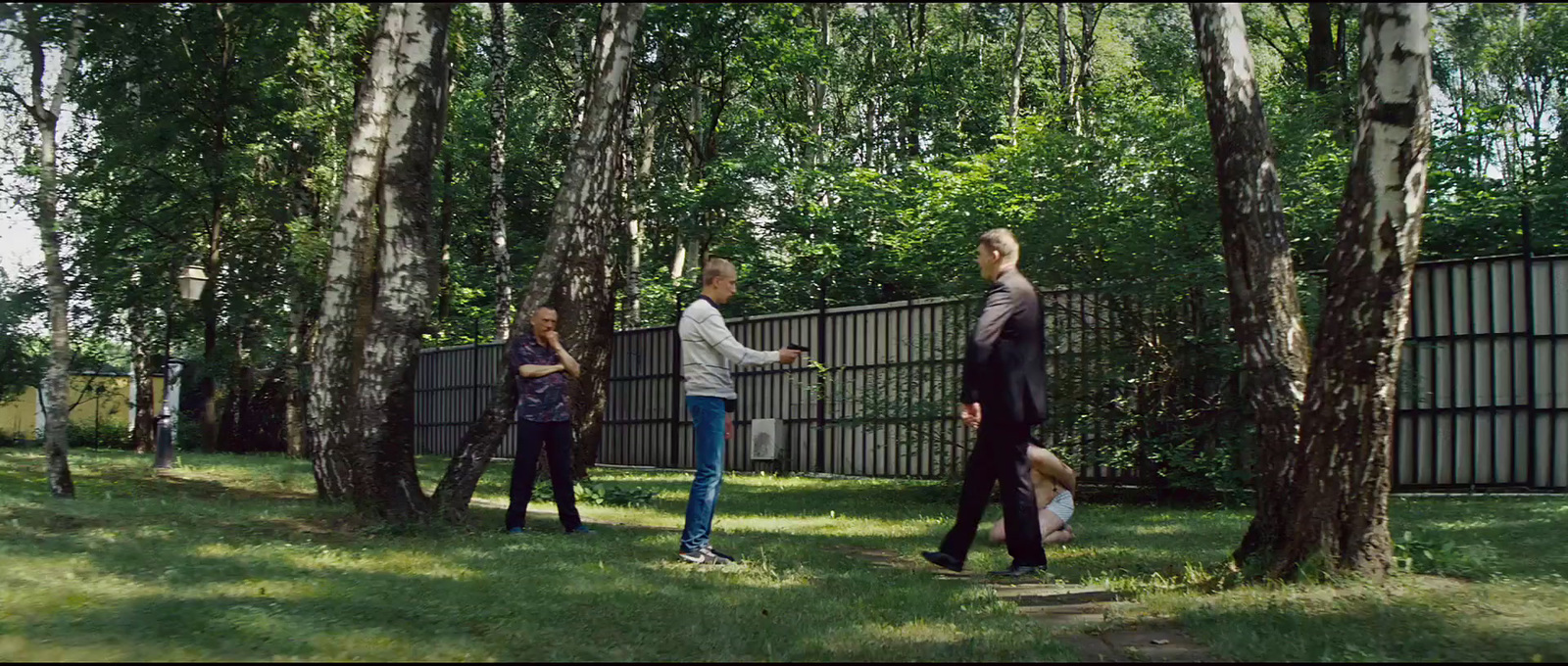 a group of people standing next to each other near trees