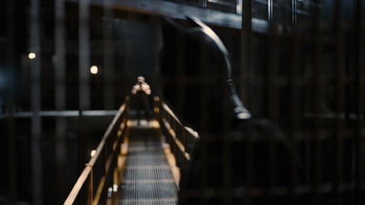 a person walking down a wooden walkway in a building