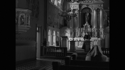 a man sitting on a bench in a church