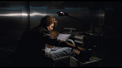 a person sitting in a chair in a dark room