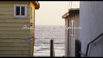 a view of the ocean from a narrow alley way