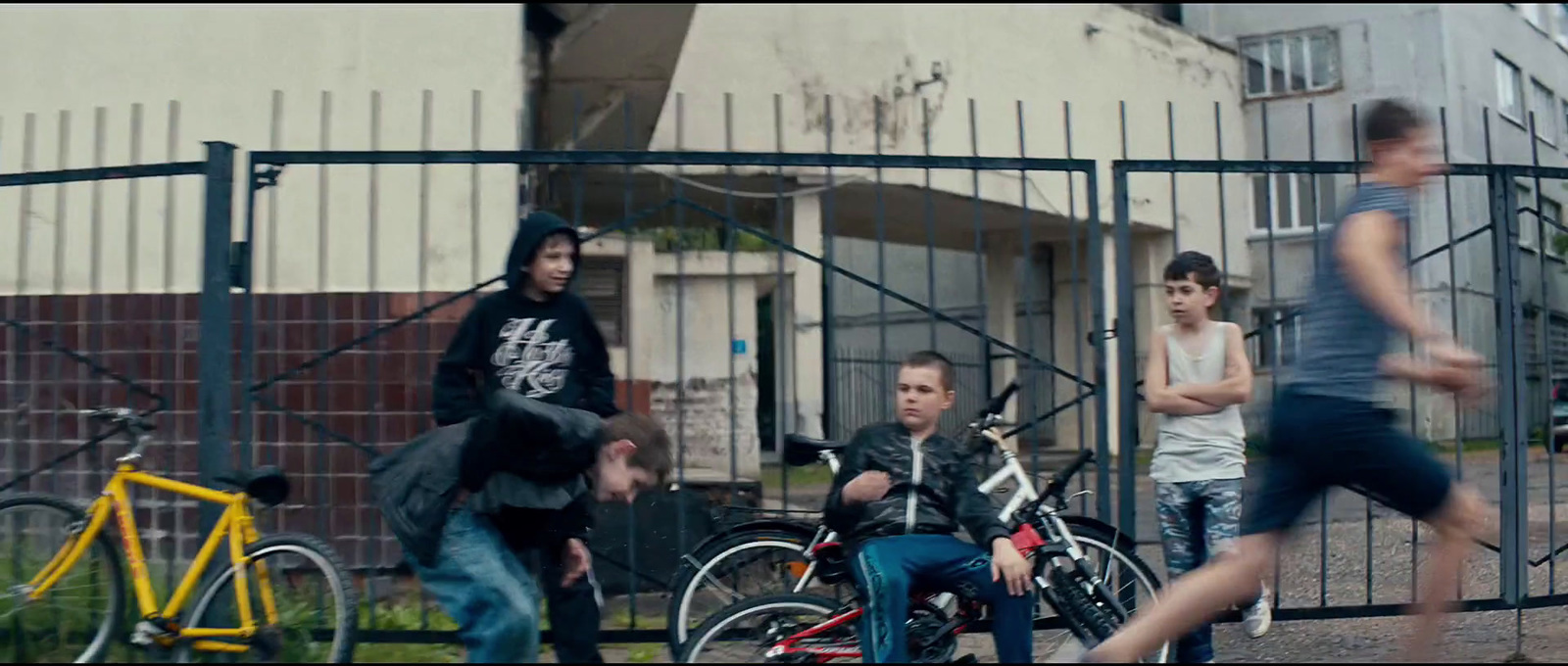 a group of young men riding bikes down a street