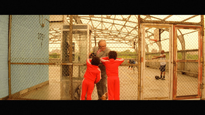 a group of people standing in a caged area