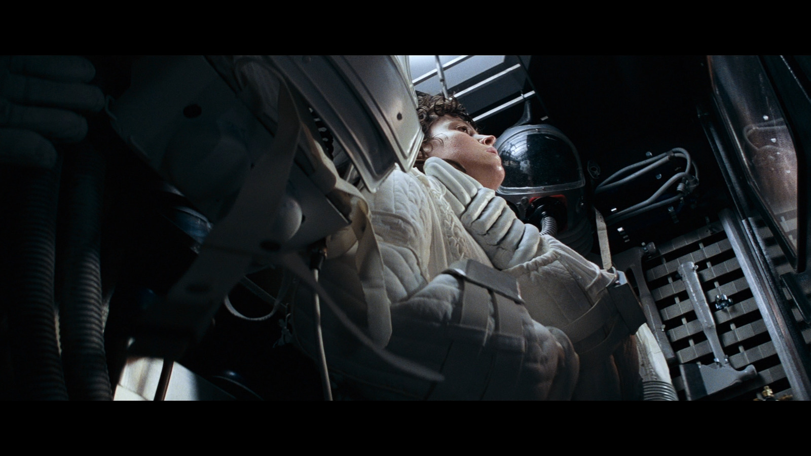 a man in a space suit sleeping in a space station