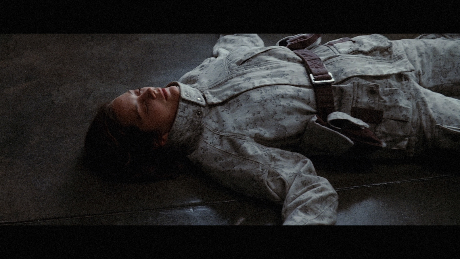 a woman laying on the ground in a military uniform