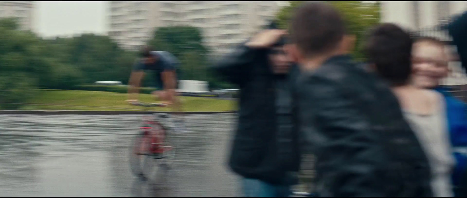 a man riding a skateboard down a street next to a woman