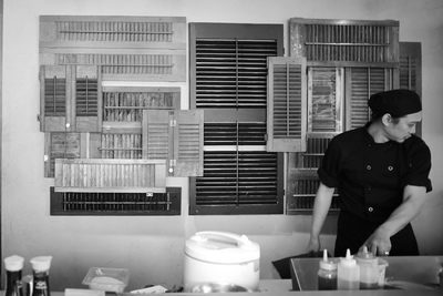 a man standing in front of a wall covered in shutters