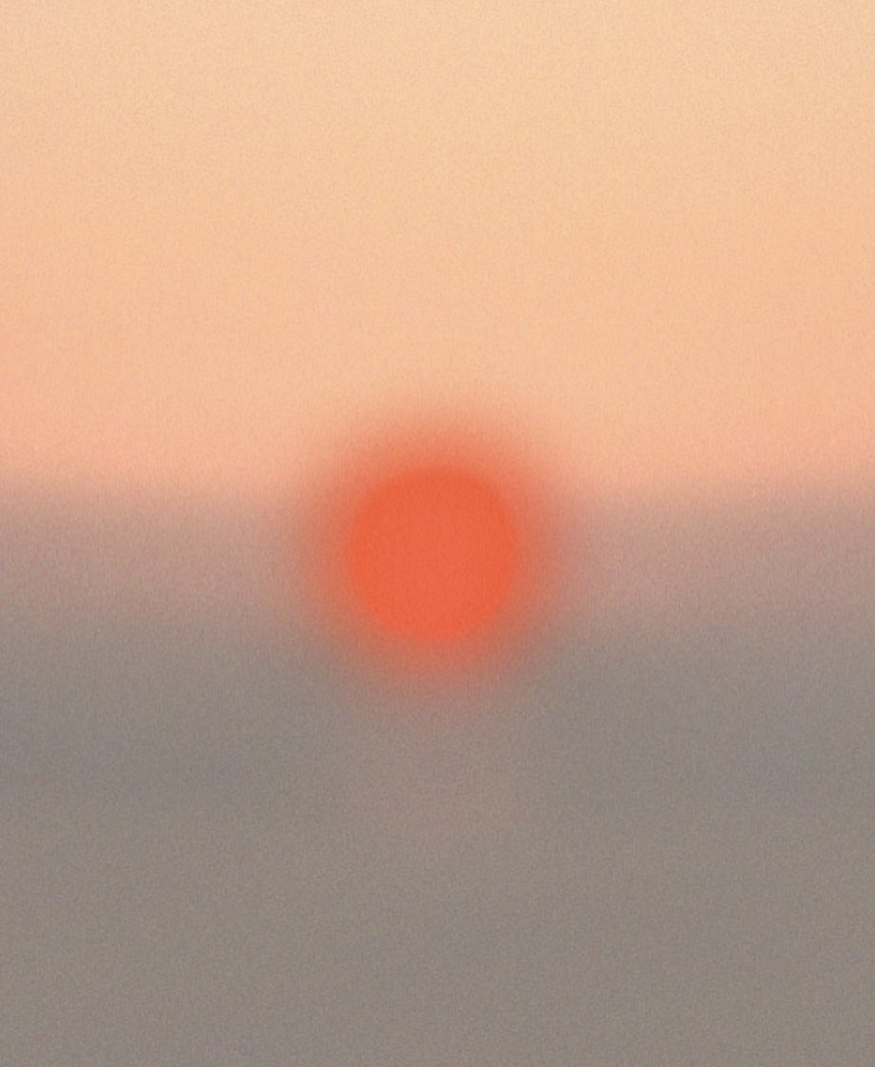 a blurry photo of a red sun in the sky