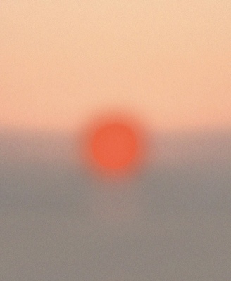 a blurry photo of a red sun in the sky