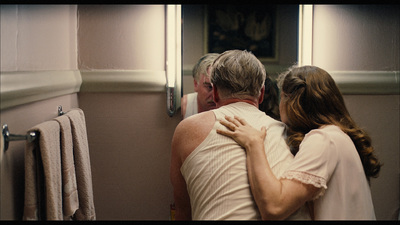 a man and a woman hugging in a bathroom