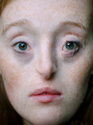 a close up of a woman with freckles on her face