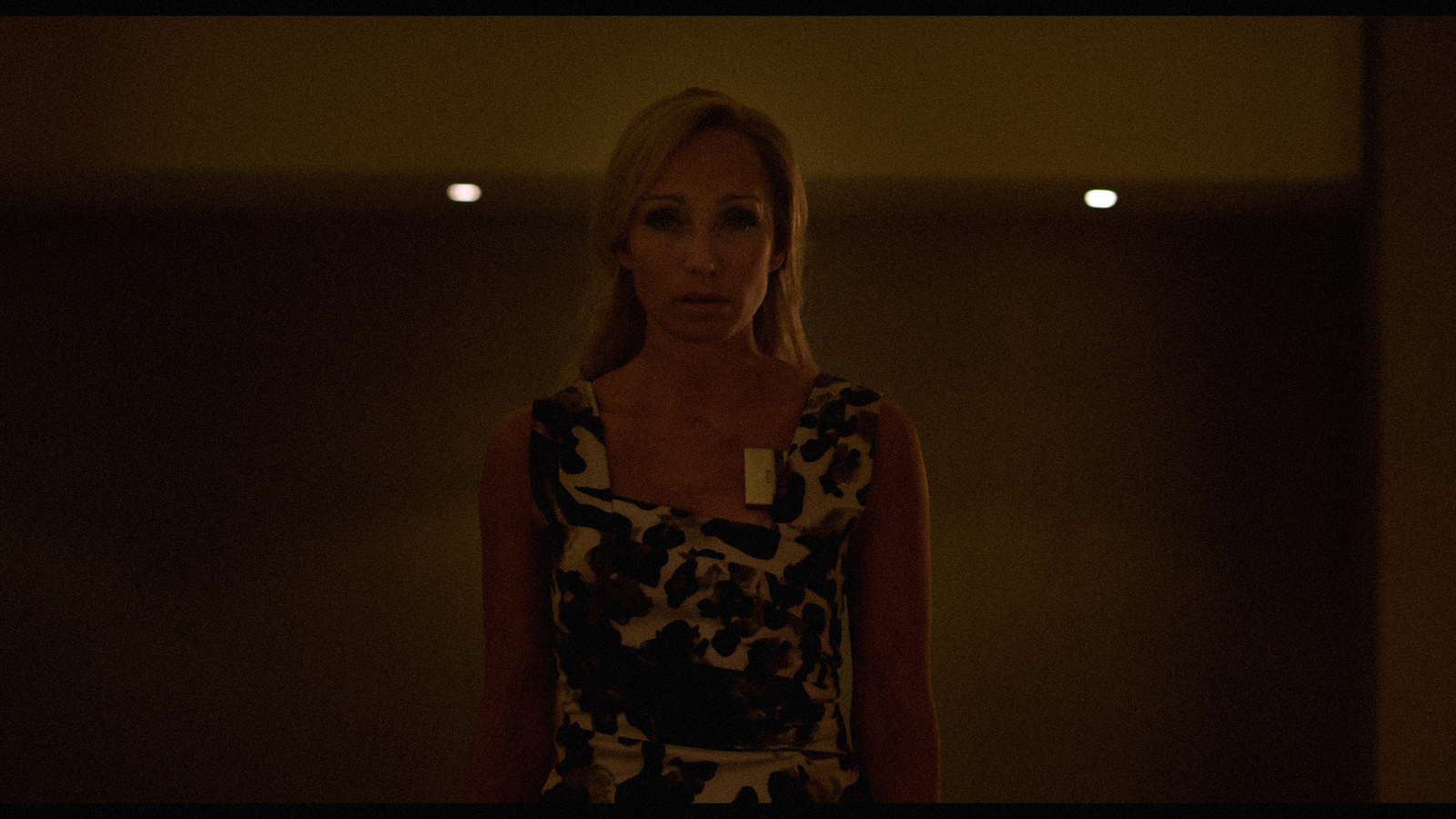 a woman standing in a dimly lit room