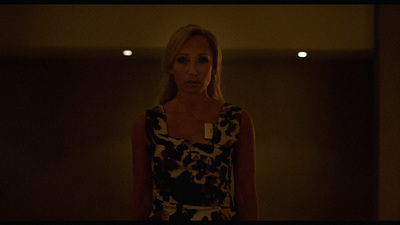 a woman standing in a dimly lit room