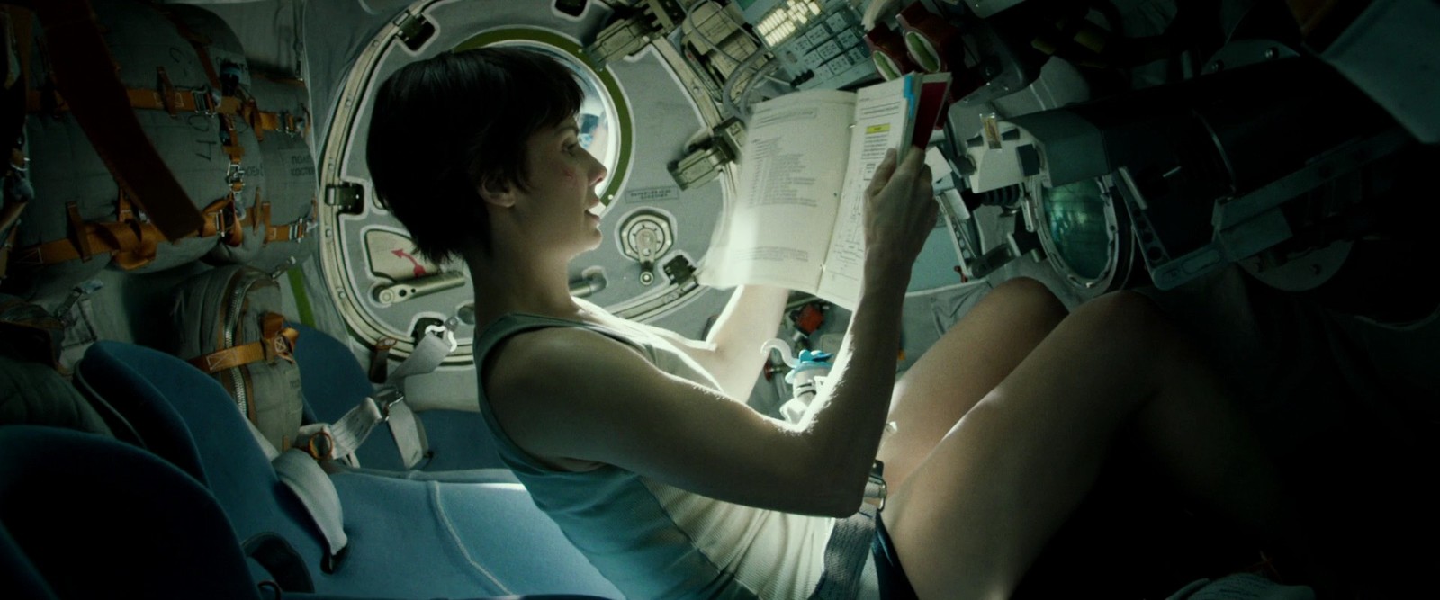 a woman is sitting in a space station