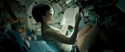 a woman is sitting in a space station