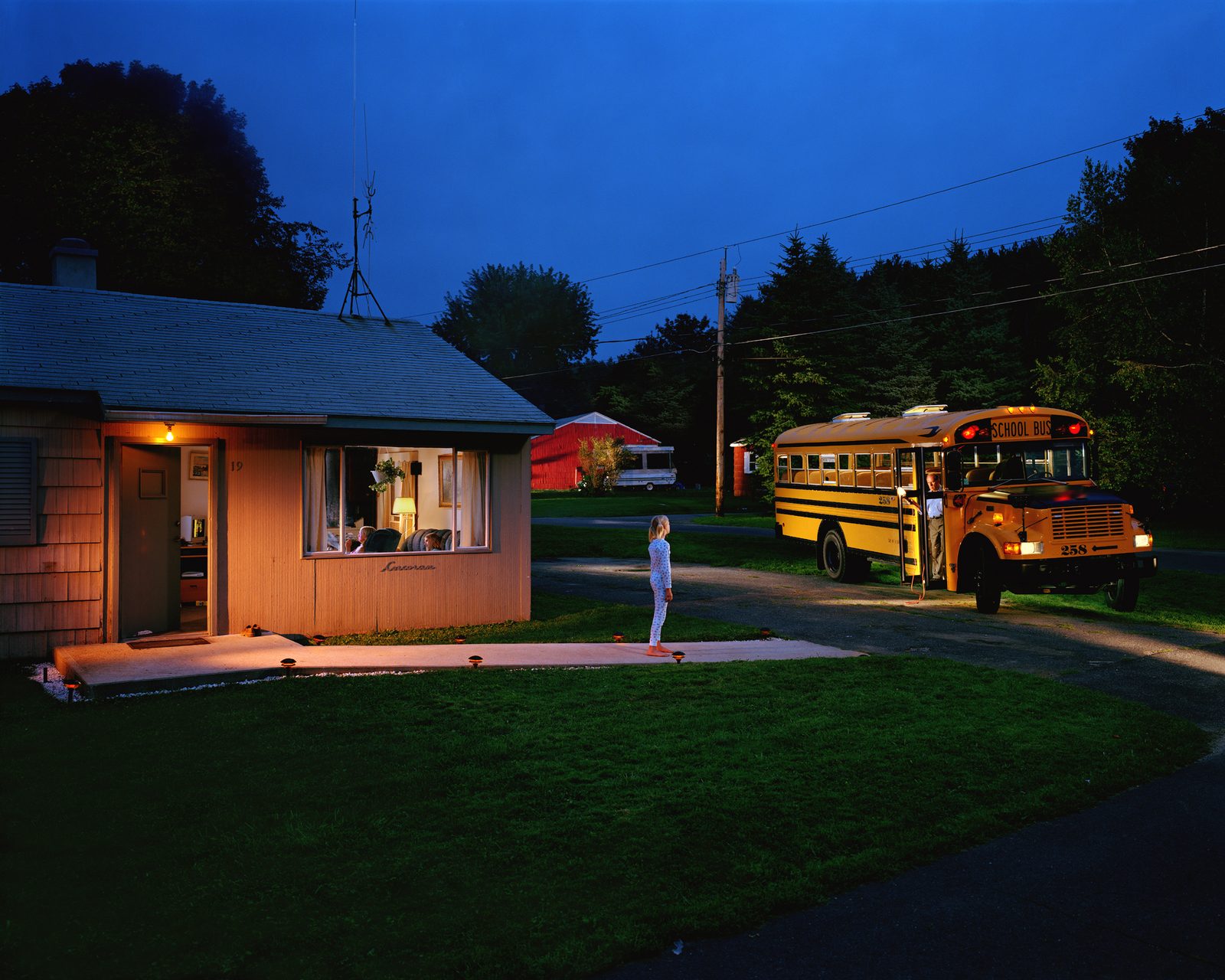 a person standing in front of a yellow school bus