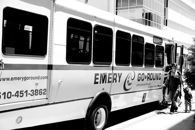 a black and white photo of people boarding a bus