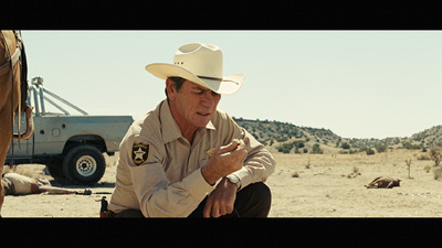 a man in a cowboy hat smoking a cigarette