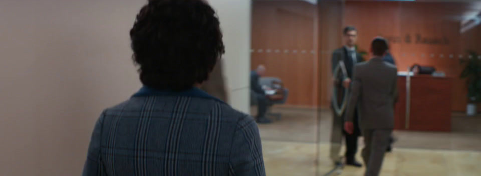 a man standing in front of a mirror in a room