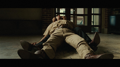 a man laying on the ground next to another man