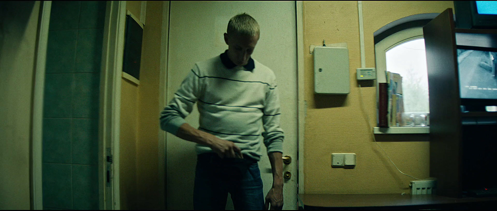 a man standing in front of a tv in a room