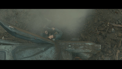 a man laying on top of a pile of rubble