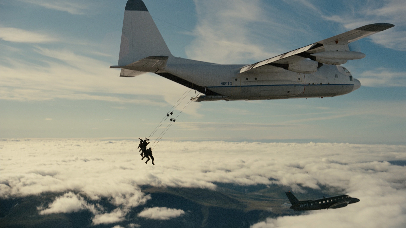 a person on a parachute being pulled by a plane