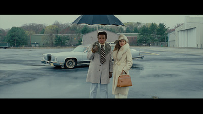 a man and a woman standing under an umbrella