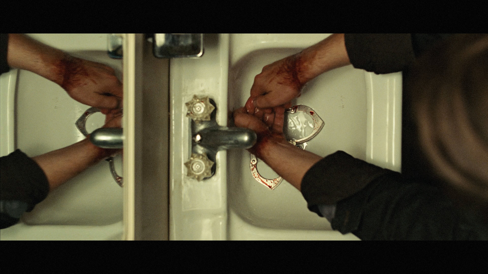 a person fixing a sink with a wrench