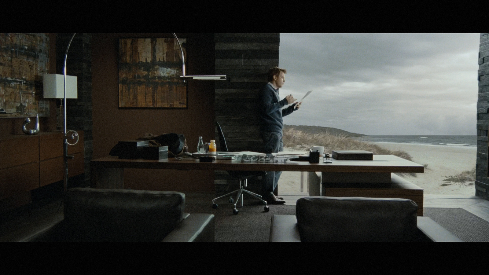 a man standing in front of a desk in a room