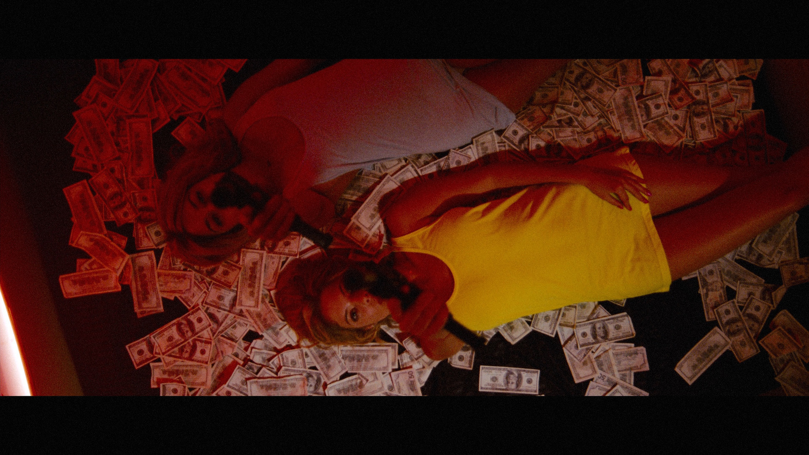 a couple of people laying on top of a pile of money