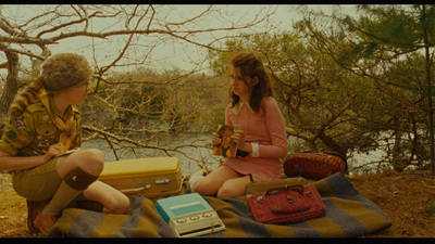 a couple of people sitting on a blanket