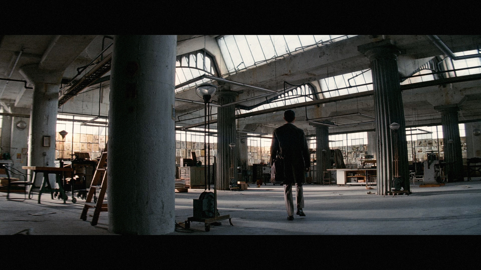 a man standing in a large industrial building