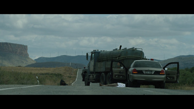 a truck and a car on the side of the road