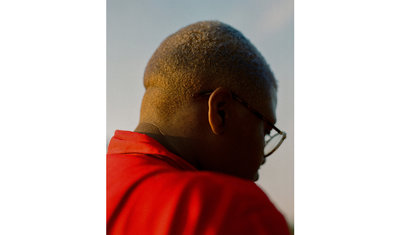 a man with glasses and a red shirt