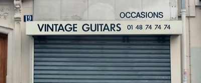 a garage door with a sign that says vintage guitars