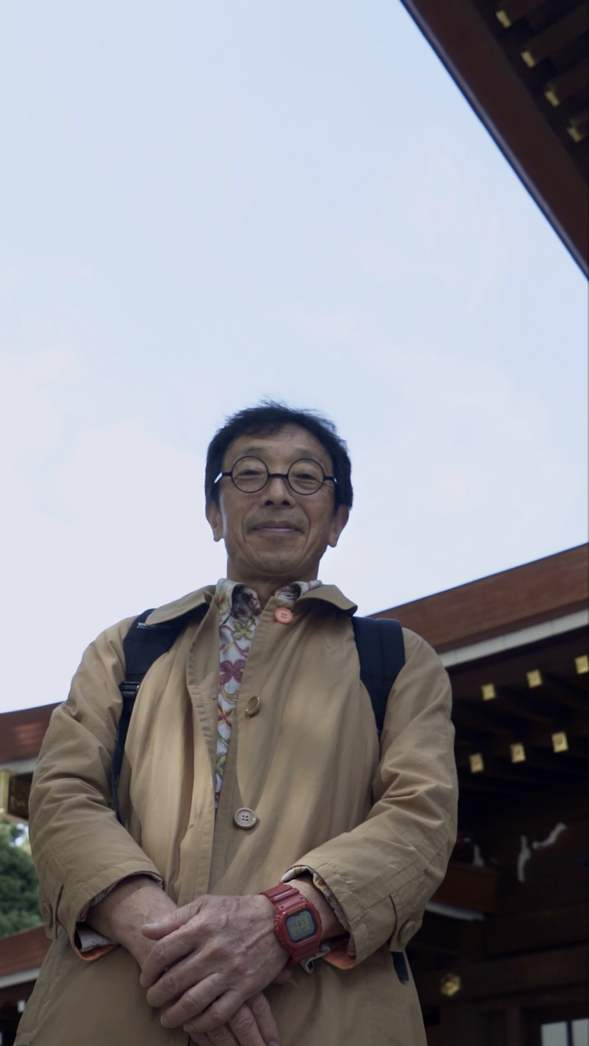 a man with a backpack standing in front of a building