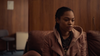 a woman sitting on a couch in a room