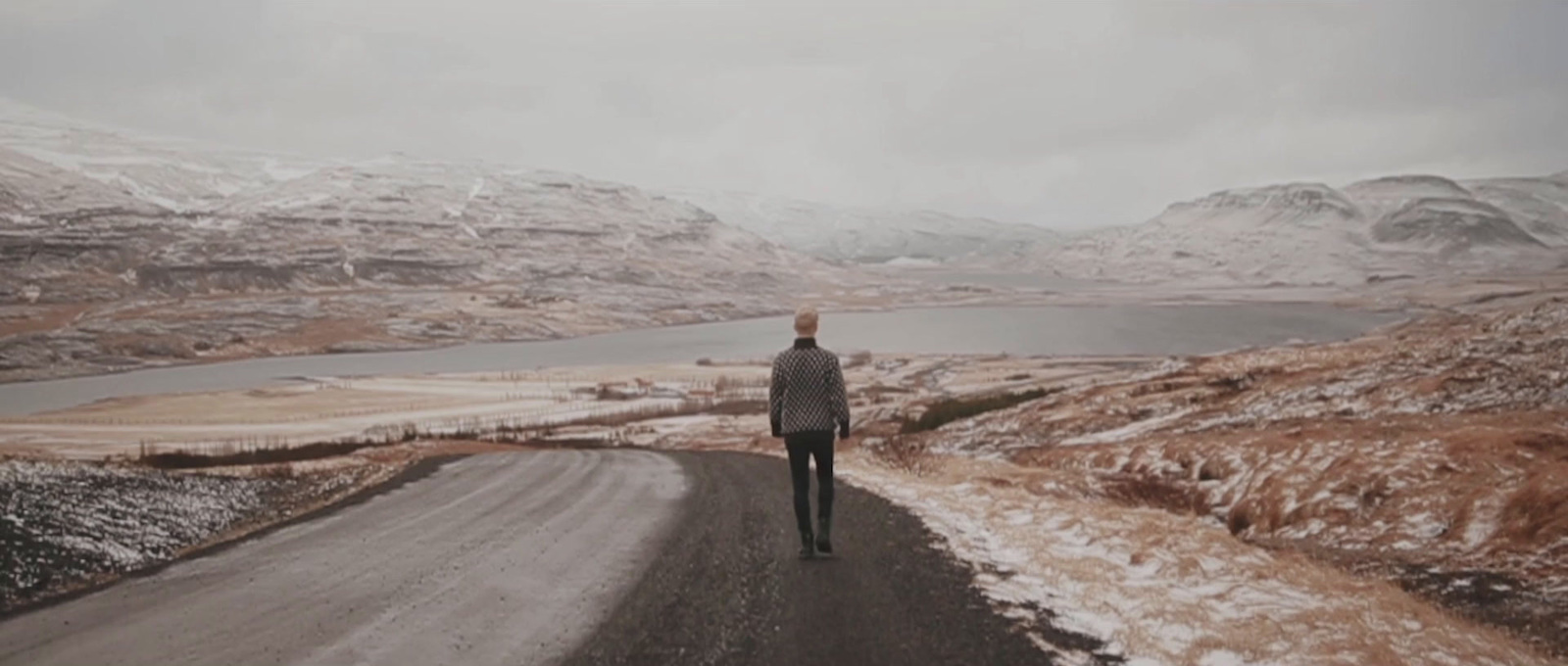 a person standing on a road in the middle of nowhere