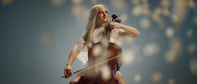 a woman holding a violin in her right hand