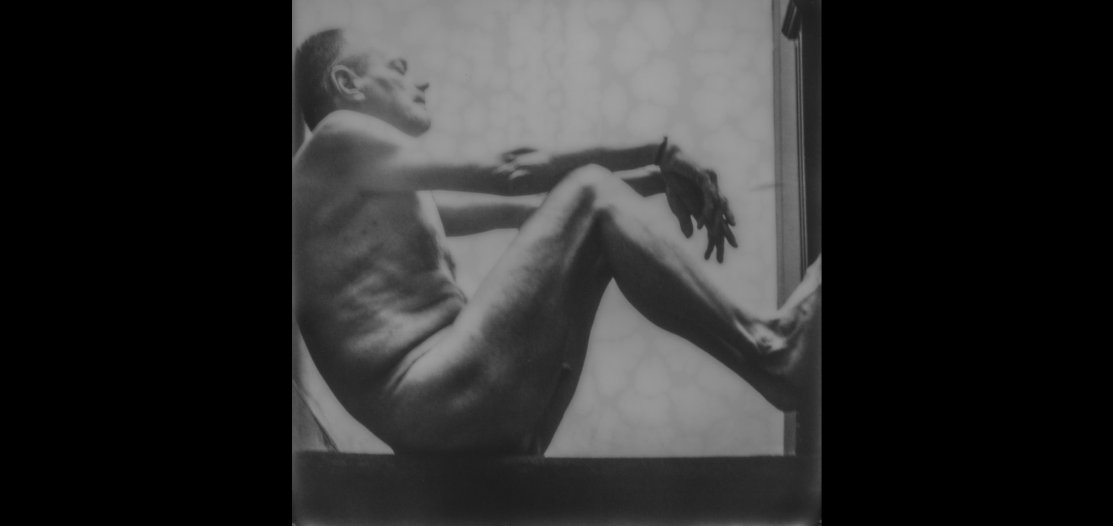 a black and white photo of a naked man