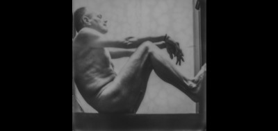 a black and white photo of a naked man