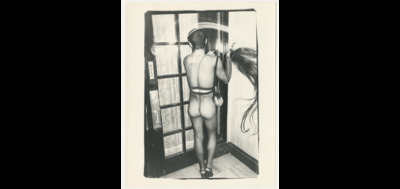 an old photo of a naked woman in a window