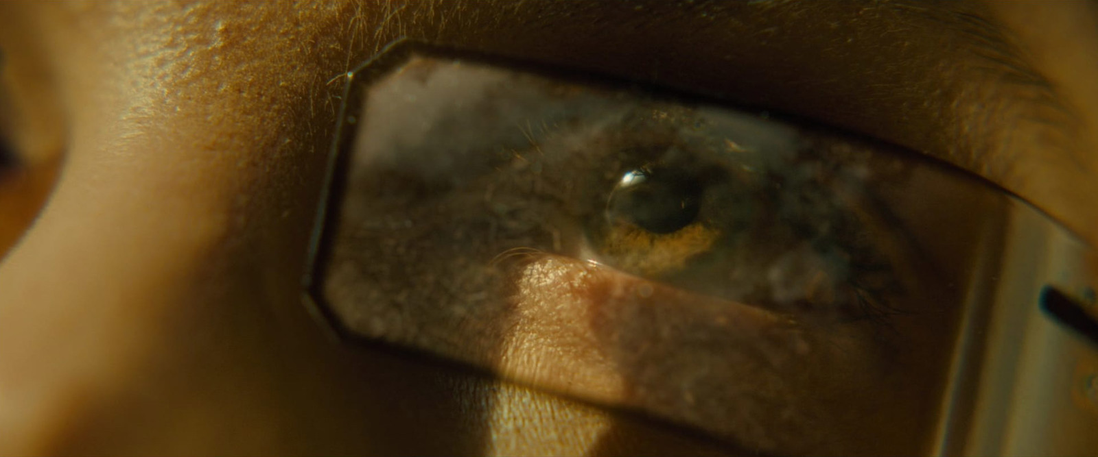 a close up of a person's face through a magnifying glass